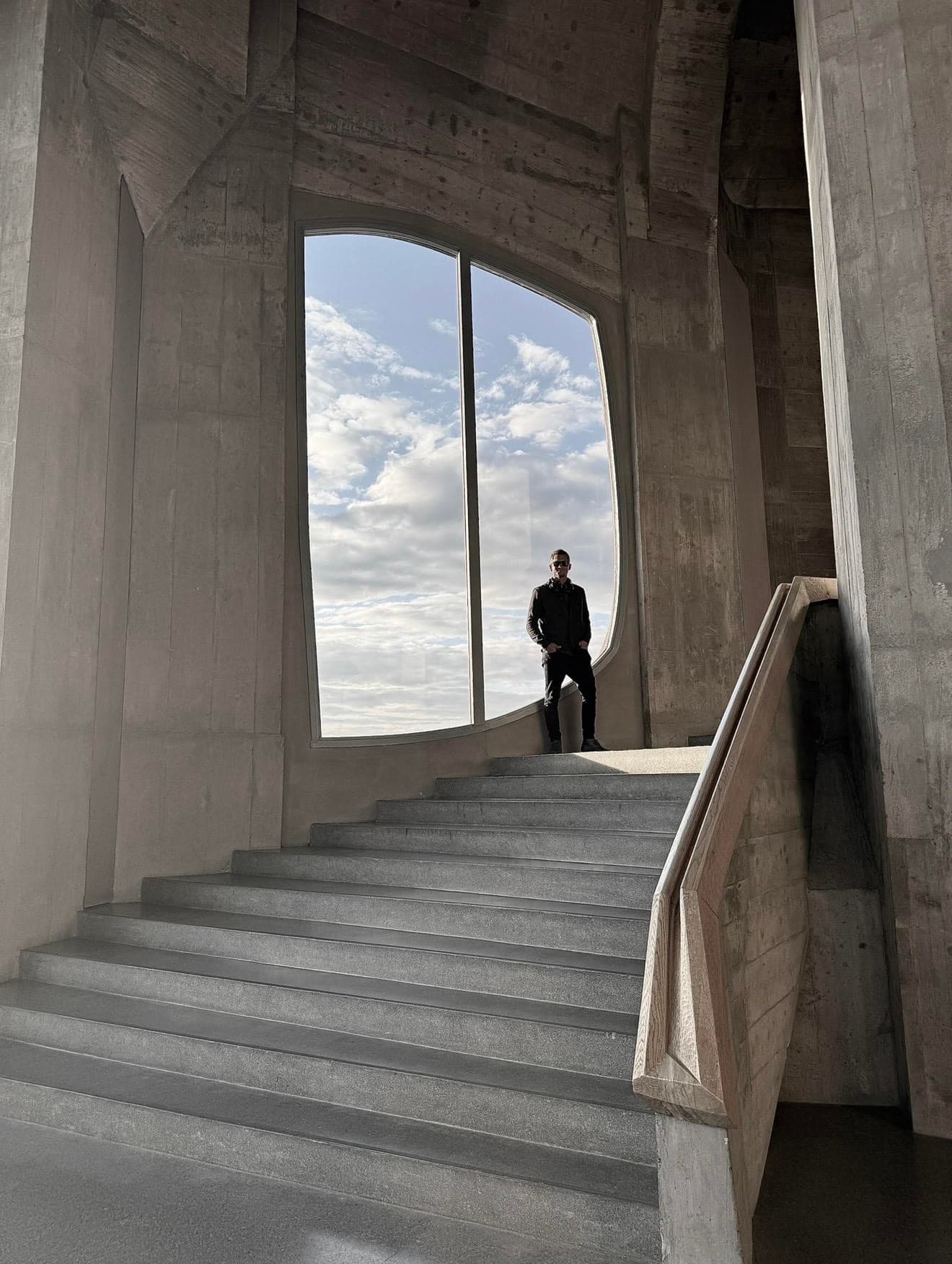 Sky Mathis standing within a monumental stone interior
